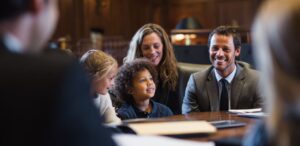 Family law attorney for adoption supporting parents and children during adoption finalization in a courtroom setting