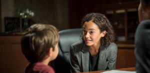 Guardian ad litem lawyer offering reassurance to a child during a juvenile dependency case, child advocacy and support.