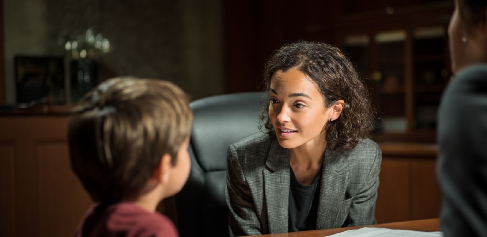 Guardian ad litem lawyer offering reassurance to a child during a juvenile dependency case, child advocacy and support.