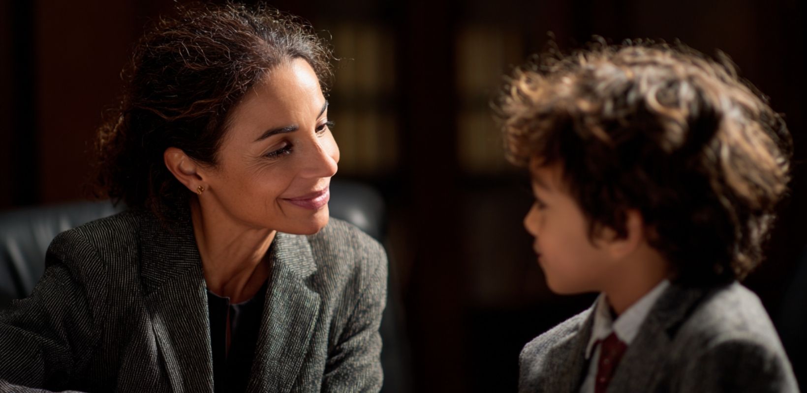 Guardian ad litem lawyer meeting with a child in a courtroom setting, providing support and advocacy in juvenile dependency cases.