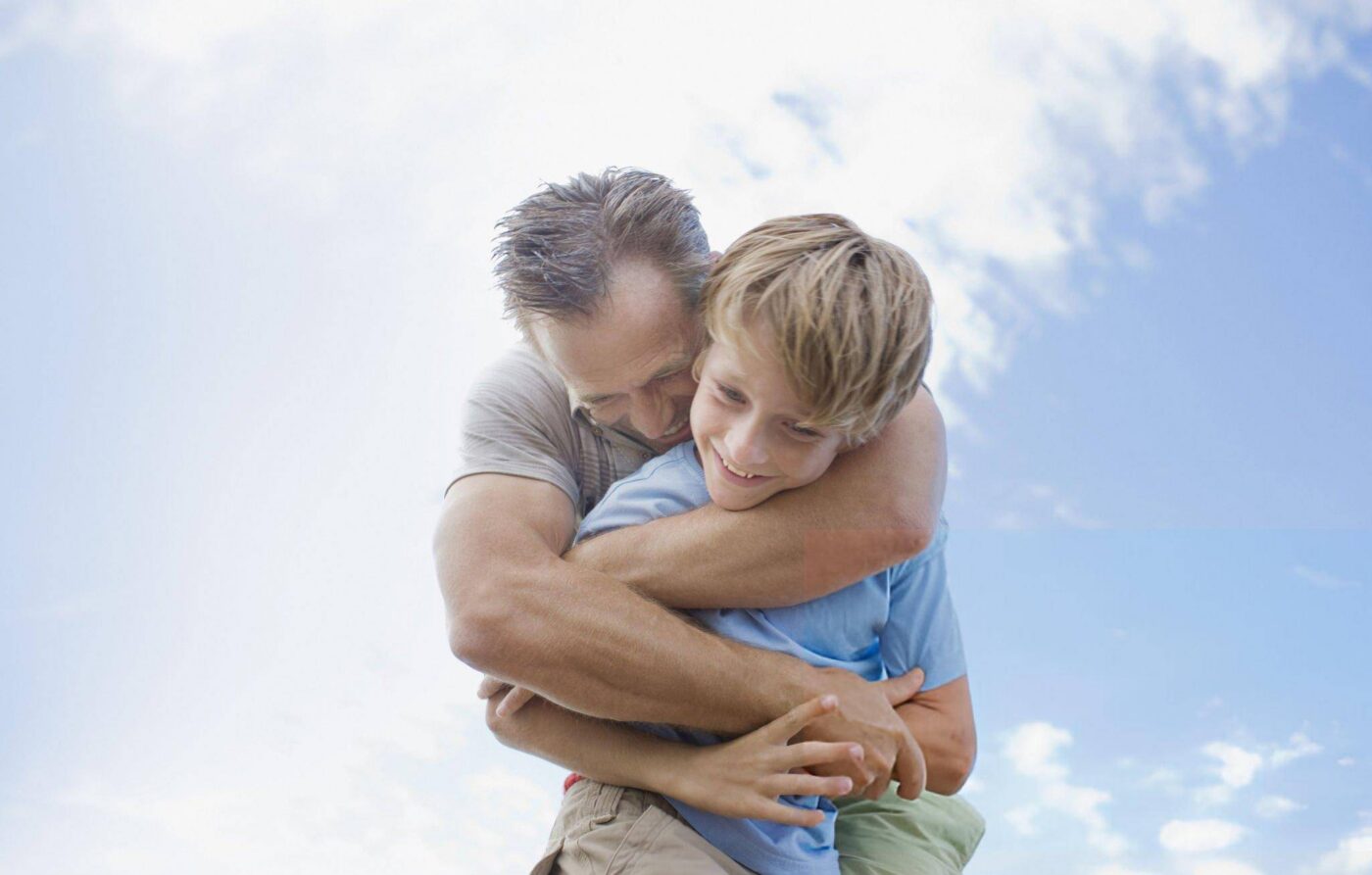 father hugging his son