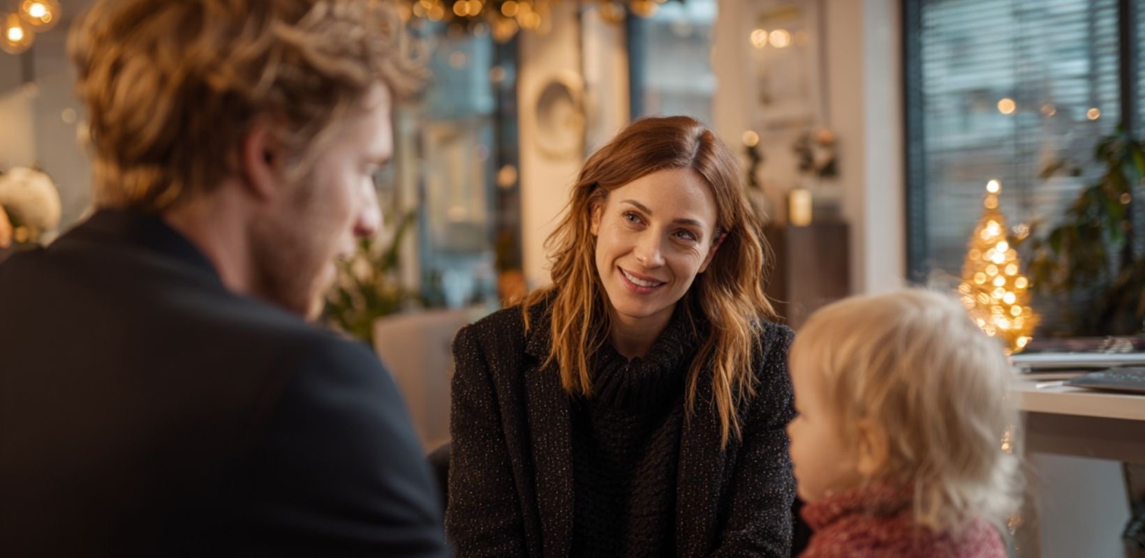 Florida juvenile dependency lawyer meeting with a family during the holiday season in a warmly decorated office.